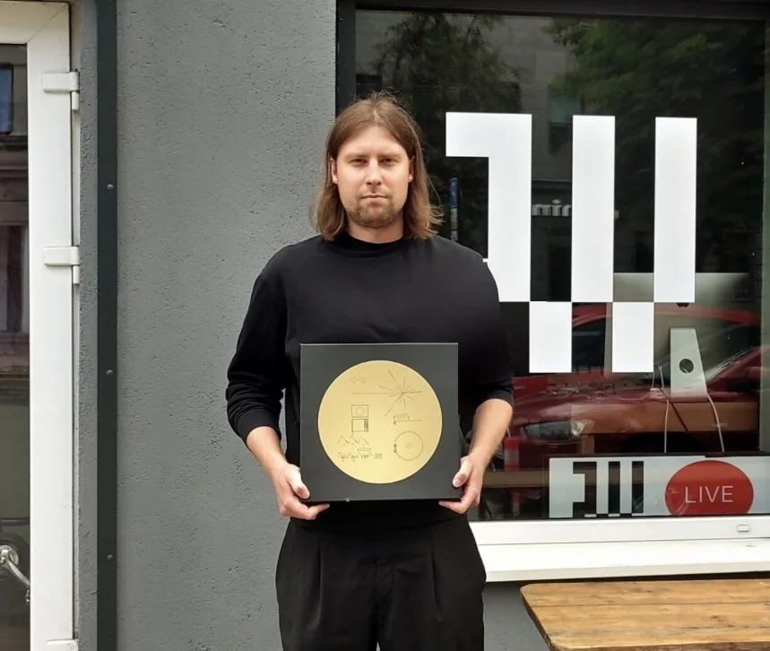Adomas Valantinas holding the Voyager Golden Record outside the Radio Vilnius studio